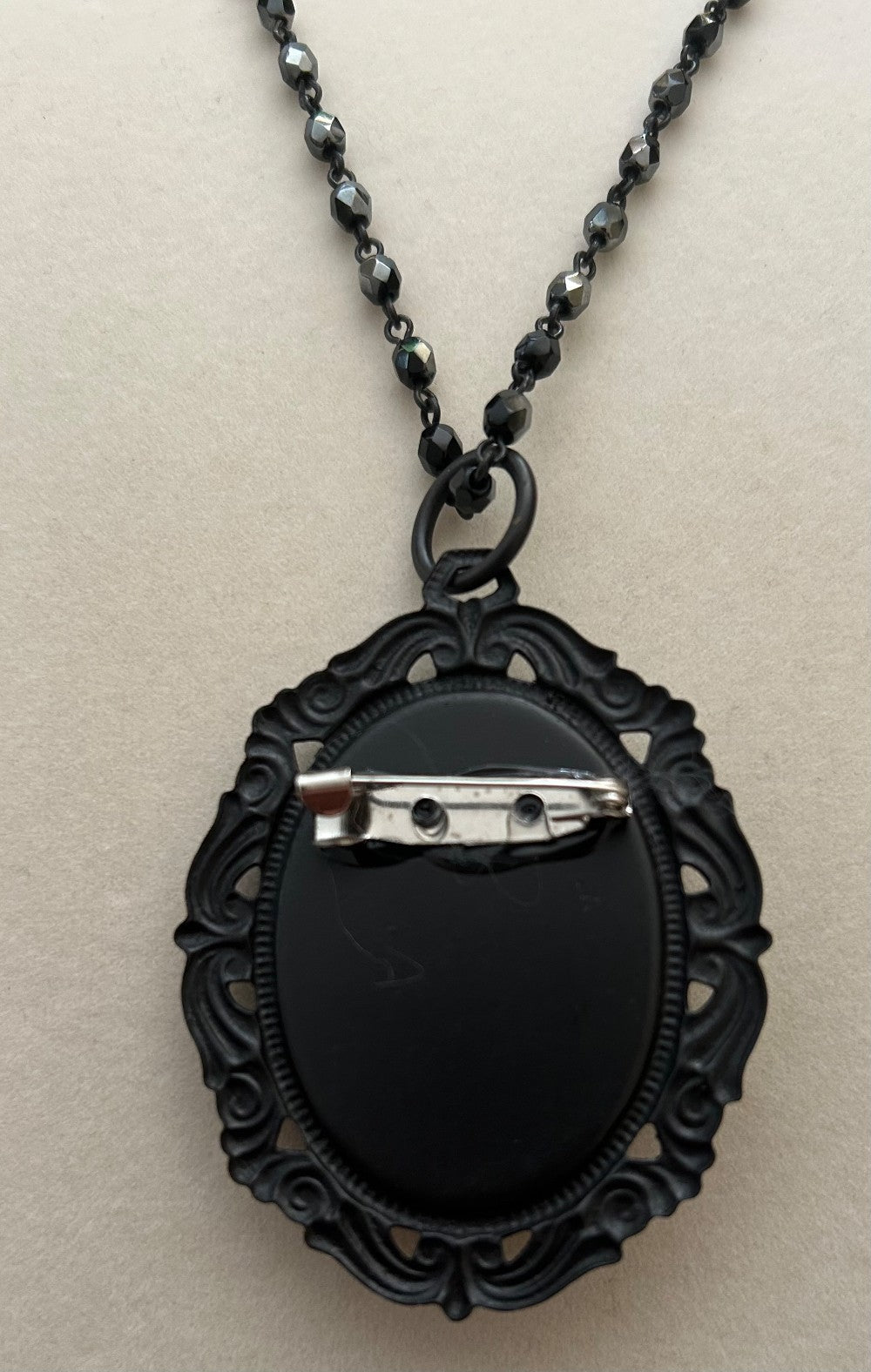 Seated Fairy Cameo Pendant/Brooch with a 22” Jet Black Beaded Chain of faceted beads|880